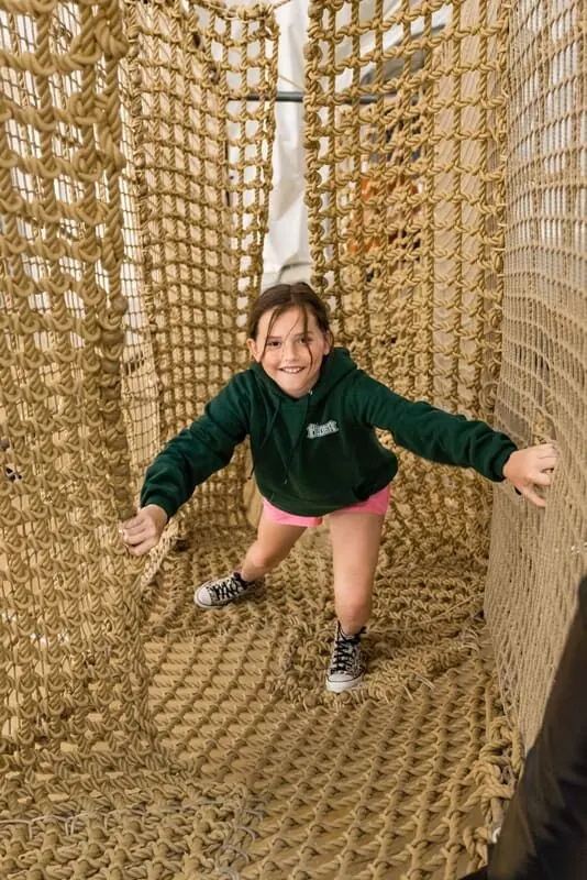 Child climbing through the Adventure Nets