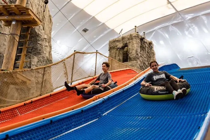 Guests racing down the Tubing Slides