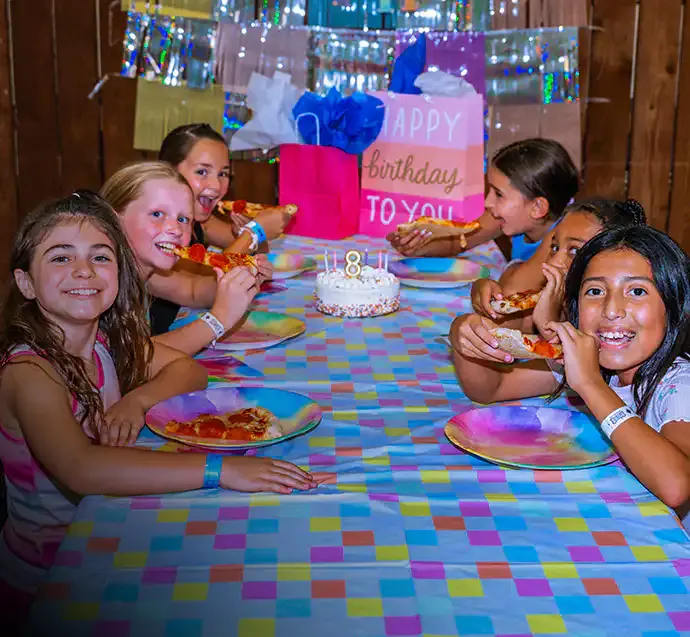 Kids celebrating at a Bolder birthday party table